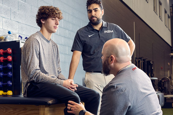 Sports physicians evaluating athlete