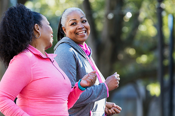 Two women jogging and laughing